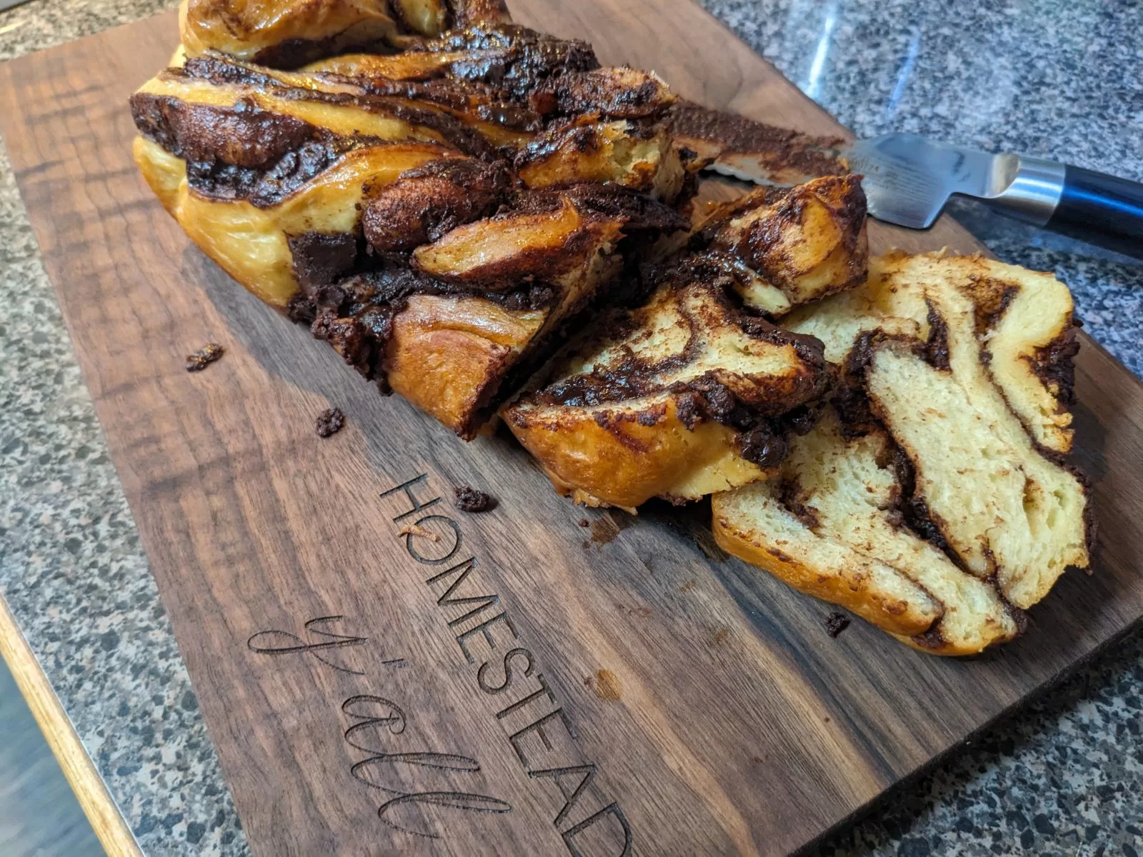 chocolate babka on walnut cutting board that says homestead yall